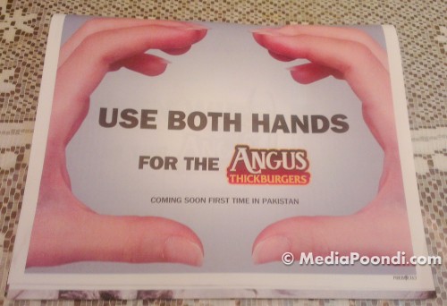 Use both hands to hold the buns on your Angus.